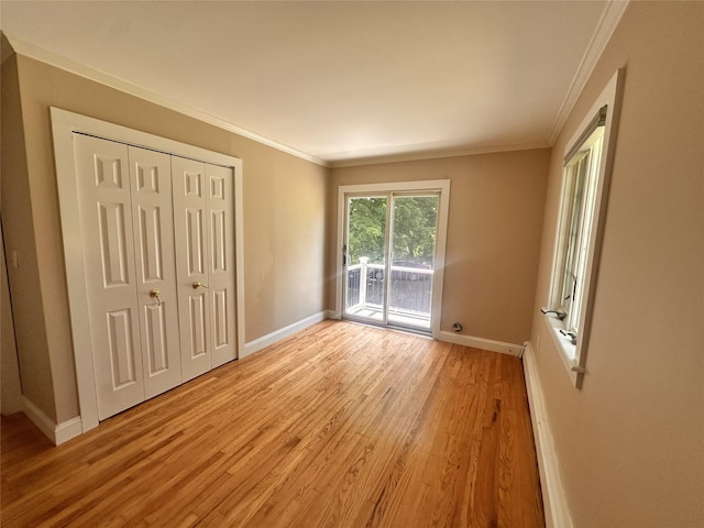 3206 Sharon Tpke, Millbrook, NY 12545 - unfurnished bedroom featuring access to exterior, baseboards, light wood-style floors, ornamental molding, and a closet
