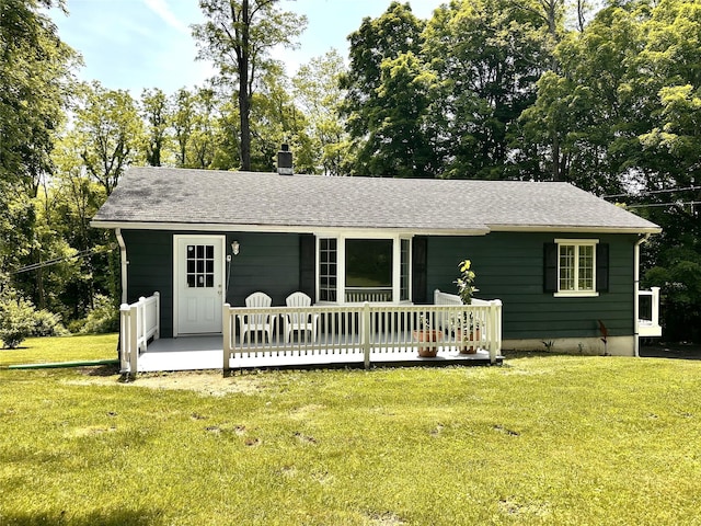 3206 Sharon Tpke, Millbrook, NY 12545 - view of front of home with a front yard, a shingled roof, a deck, and view of scattered trees