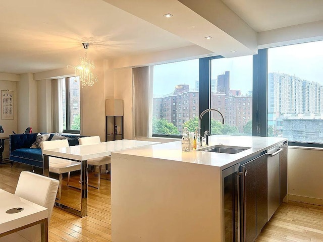 39-16 Prince St Unit 5C, Flushing, NY 11365 - kitchen featuring wine cooler, a sink, light wood-type flooring, and a chandelier