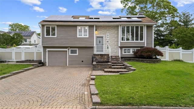55 Newton Ave, Selden, NY 11784 - bi-level home featuring decorative driveway, solar panels, an attached garage, and stone siding