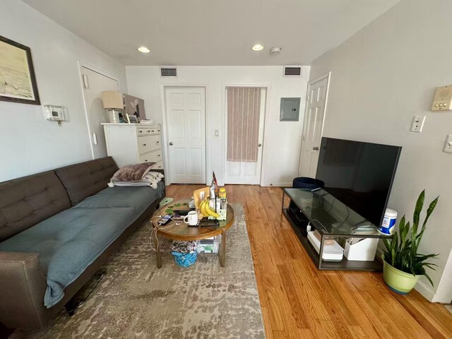 103-02 42nd Ave Unit 4D, Corona, NY 11368 - living room featuring light wood-style floors, electric panel, and recessed lighting