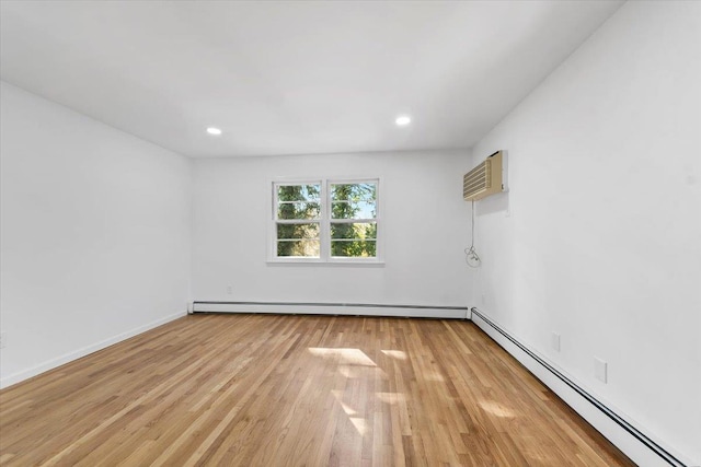 10 Mohawk Rd, Yonkers, NY 10710 - spare room featuring baseboard heating, light wood finished floors, a wall mounted AC, recessed lighting, and baseboards
