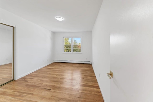 10 Mohawk Rd, Yonkers, NY 10710 - unfurnished bedroom featuring a baseboard radiator, light wood-style floors, and baseboards