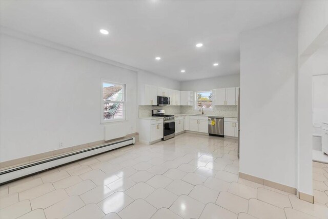 10 Mohawk Rd, Yonkers, NY 10710 - kitchen with appliances with stainless steel finishes, baseboard heating, light countertops, recessed lighting, and white cabinetry