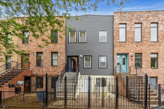 593 Van Buren St, Brooklyn, NY 11221 - townhome / multi-family property featuring a fenced front yard and a gate