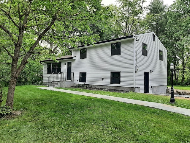 495 Stanton Ter, Poughkeepsie, NY 12603 - rear view of property with a yard and view of wooded area