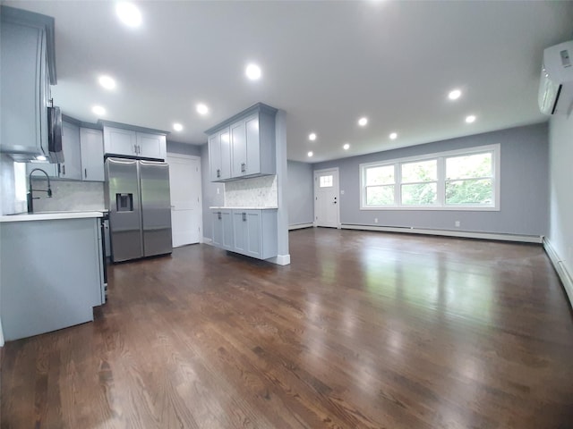 495 Stanton Ter, Poughkeepsie, NY 12603 - kitchen with stainless steel fridge, a baseboard radiator, decorative backsplash, light countertops, and a wall unit AC
