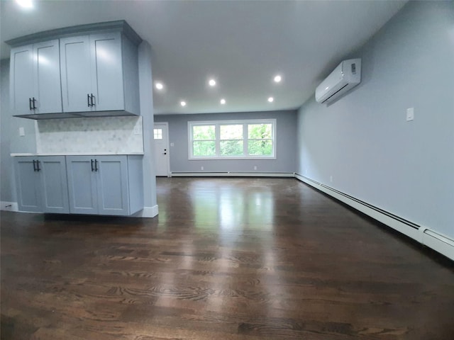 495 Stanton Ter, Poughkeepsie, NY 12603 - unfurnished living room featuring a wall mounted AC, dark wood-style floors, a baseboard radiator, recessed lighting, and baseboard heating