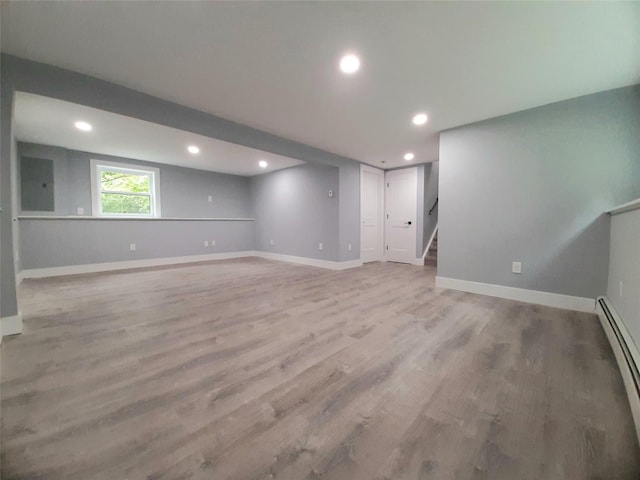 495 Stanton Ter, Poughkeepsie, NY 12603 - below grade area featuring stairs, light wood-style floors, a baseboard heating unit, baseboards, and recessed lighting