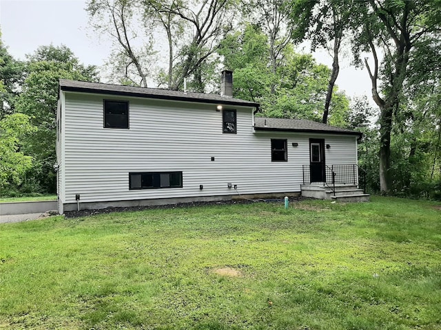 495 Stanton Ter, Poughkeepsie, NY 12603 - back of house featuring a chimney and a yard