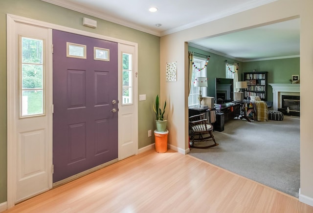 36 Valkill Dr, Poughkeepsie, NY 12601 - foyer featuring wood finished floors, crown molding, baseboards, a fireplace, and recessed lighting