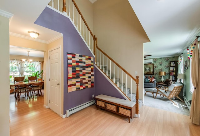36 Valkill Dr, Poughkeepsie, NY 12601 - stairway with baseboard heating, wood finished floors, crown molding, a chandelier, and wallpapered walls