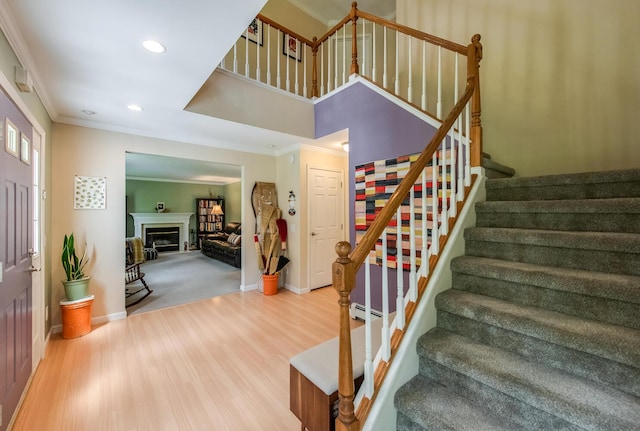 36 Valkill Dr, Poughkeepsie, NY 12601 - stairway featuring crown molding, wood finished floors, baseboards, recessed lighting, and a fireplace