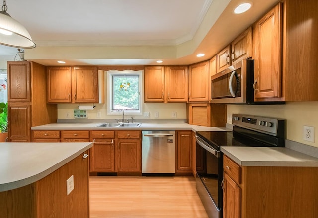 36 Valkill Dr, Poughkeepsie, NY 12601 - kitchen featuring appliances with stainless steel finishes, a sink, ornamental molding, light wood finished floors, and brown cabinetry