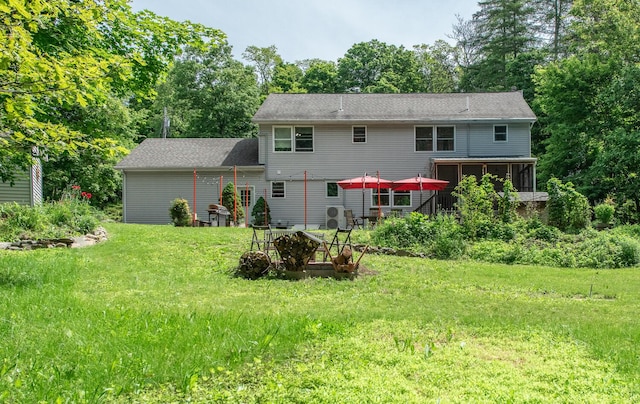 36 Valkill Dr, Poughkeepsie, NY 12601 - rear view of property with a sunroom, a yard, and view of wooded area