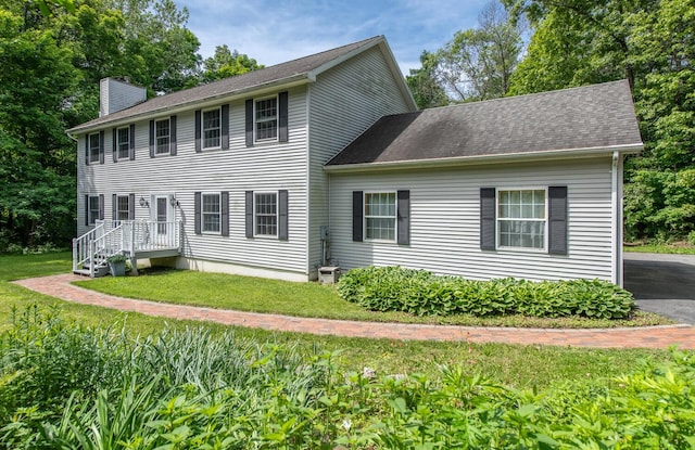 36 Valkill Dr, Poughkeepsie, NY 12601 - colonial-style house featuring a chimney, a front yard, and roof with shingles