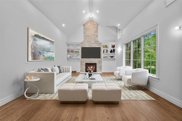 3 Hageman Ct, Katonah, NY 10536 - living area featuring baseboards, healthy amount of natural light, wood finished floors, a stone fireplace, and high vaulted ceiling
