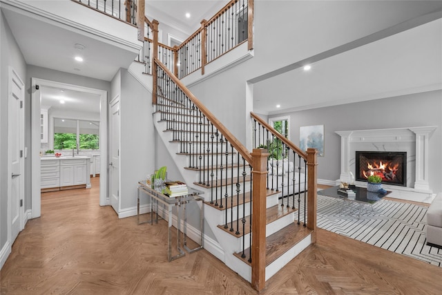 3 Hageman Ct, Katonah, NY 10536 - stairs featuring baseboards, a fireplace, recessed lighting, ornamental molding, and a high ceiling
