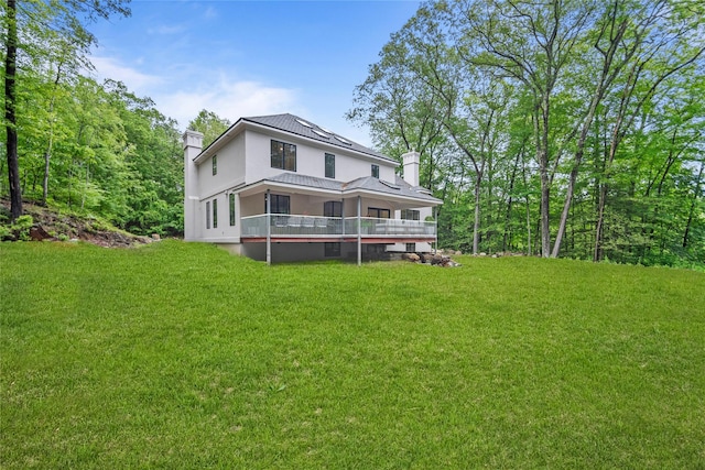 3 Hageman Ct, Katonah, NY 10536 - back of property with a chimney, a lawn, and stucco siding