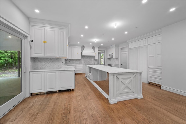 3 Hageman Ct, Katonah, NY 10536 - kitchen with custom exhaust hood, white cabinets, healthy amount of natural light, backsplash, and recessed lighting