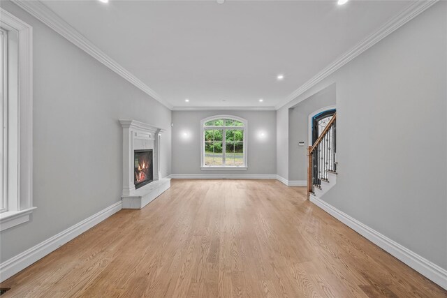 3 Hageman Ct, Katonah, NY 10536 - unfurnished living room with a lit fireplace, light wood-type flooring, recessed lighting, baseboards, and stairs