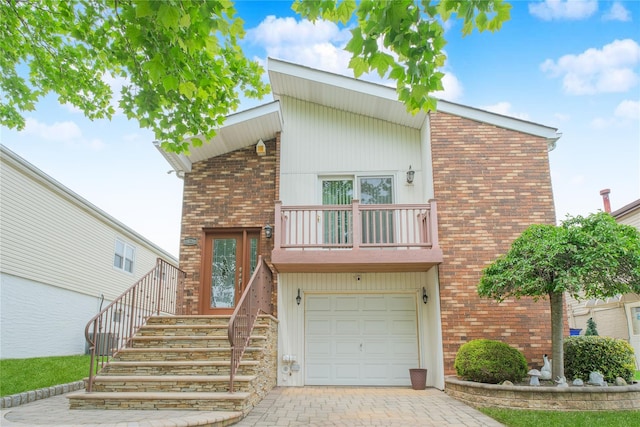 63 Dorval Ave, Staten Island, NY 10312 - view of front of property featuring a balcony, brick siding, an attached garage, decorative driveway, and stairway
