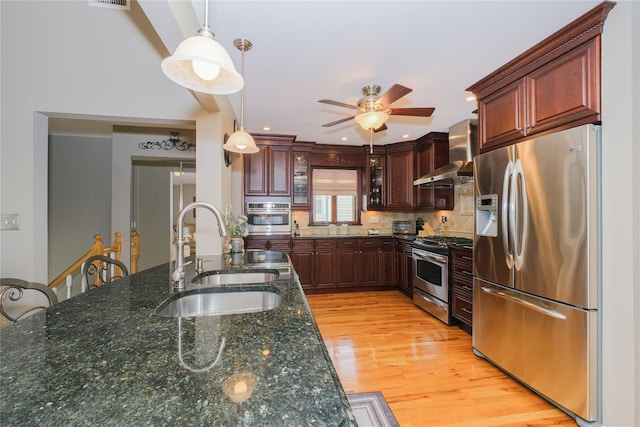 63 Dorval Ave, Staten Island, NY 10312 - kitchen with appliances with stainless steel finishes, wall chimney exhaust hood, a sink, ceiling fan, and decorative light fixtures