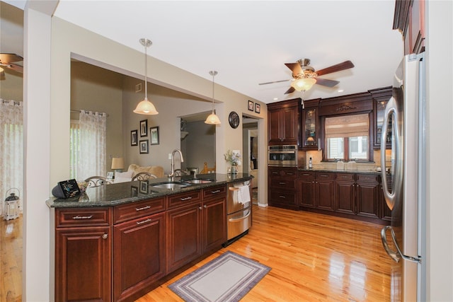 63 Dorval Ave, Staten Island, NY 10312 - kitchen featuring ceiling fan, appliances with stainless steel finishes, a sink, and light wood-style flooring