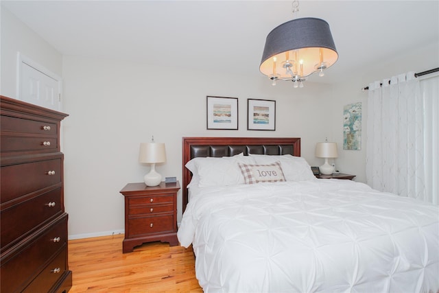 63 Dorval Ave, Staten Island, NY 10312 - bedroom with light wood finished floors, a chandelier, and baseboards