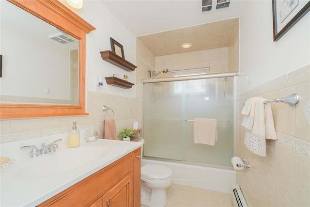 63 Dorval Ave, Staten Island, NY 10312 - full bathroom with tile walls, toilet, vanity, combined bath / shower with glass door, and baseboard heating