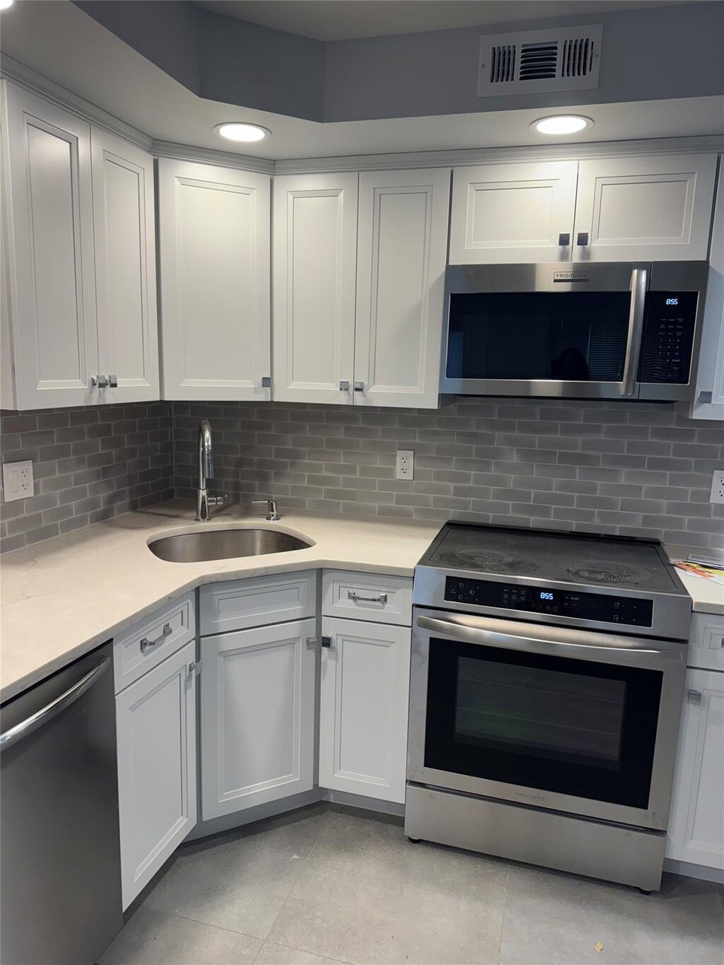 3116 Monterey Dr, Merrick, NY 11566 - kitchen featuring stainless steel appliances, a sink, and white cabinets