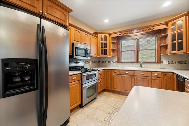 10 Stewart St, East Islip, NY 11730 - kitchen with appliances with stainless steel finishes, open shelves, a sink, tasteful backsplash, and light tile patterned floors