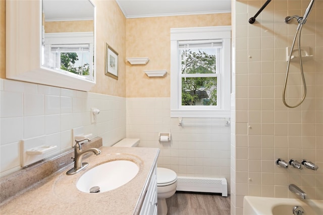 10 Stewart St, East Islip, NY 11730 - bathroom featuring a baseboard radiator, toilet, plenty of natural light, vanity, and tile walls