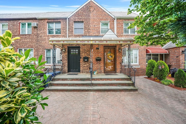 60-51 71st St, Maspeth, NY 11378 - view of property featuring brick siding and an AC wall unit
