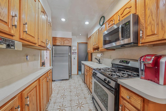 60-51 71st St, Maspeth, NY 11378 - kitchen with stainless steel appliances, a sink, light floors, light countertops, and recessed lighting