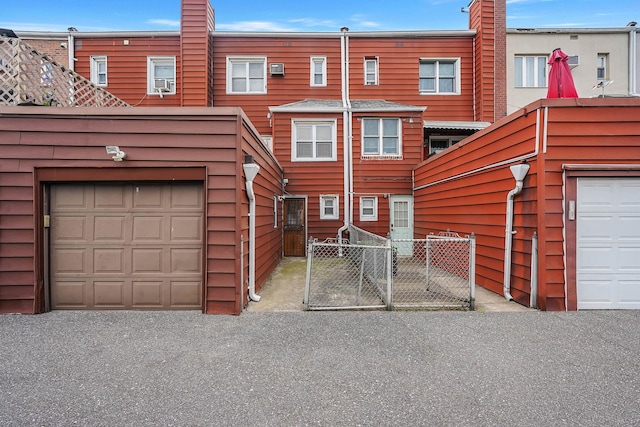60-51 71st St, Maspeth, NY 11378 - view of front facade with a gate and a chimney