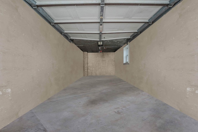 60-51 71st St, Maspeth, NY 11378 - garage featuring a textured wall and a garage door opener