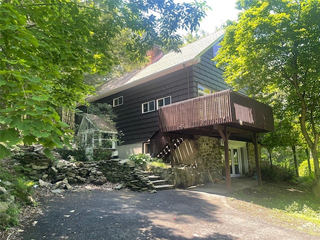 53 W Corbett Rd, Montgomery, NY 12549 - view of front facade featuring a deck, a chimney, roof with shingles, and stairs