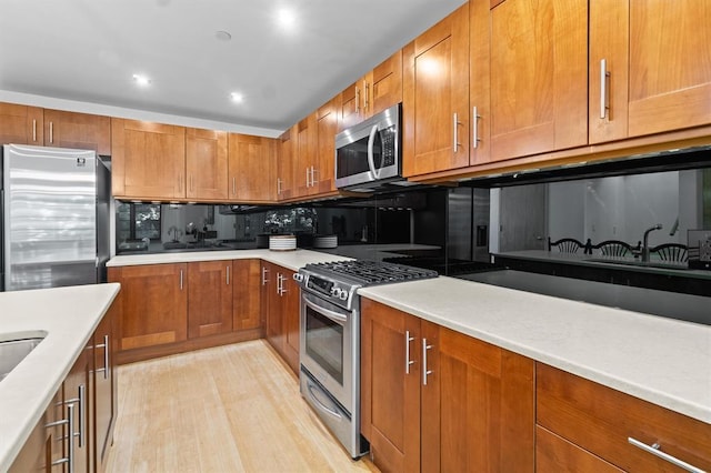 45 Main St Unit 3K, Hastings-On-Hudson, NY 10706 - kitchen featuring stainless steel appliances, brown cabinets, decorative backsplash, light countertops, and recessed lighting