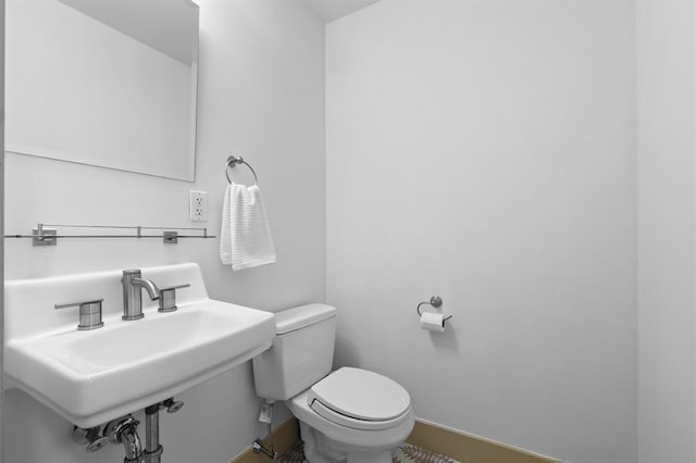45 Main St Unit 3K, Hastings-On-Hudson, NY 10706 - half bathroom with toilet, baseboards, and a sink