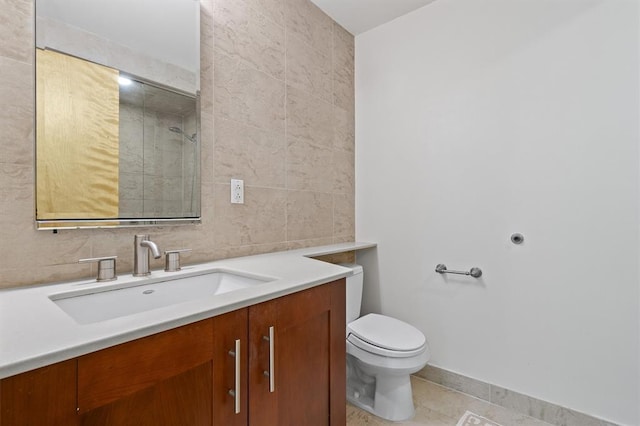 45 Main St Unit 3K, Hastings-On-Hudson, NY 10706 - bathroom featuring tile walls, vanity, tile patterned floors, toilet, and a tile shower