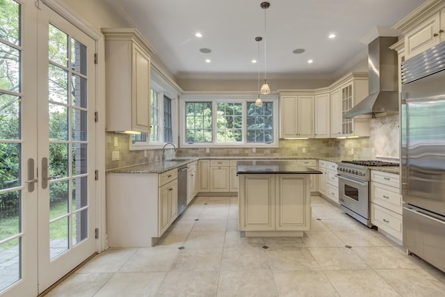 30A Shelter Rock Rd, Manhasset, NY 11030 - kitchen featuring cream cabinets, high end appliances, wall chimney range hood, healthy amount of natural light, and ornamental molding