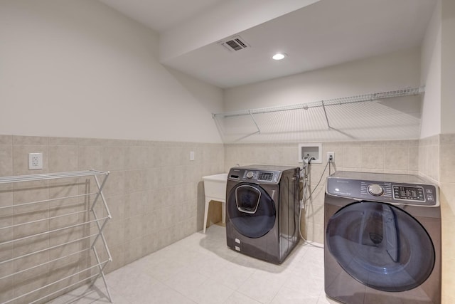 30A Shelter Rock Rd, Manhasset, NY 11030 - laundry area with tile walls, washing machine and dryer, light tile patterned floors, and wainscoting