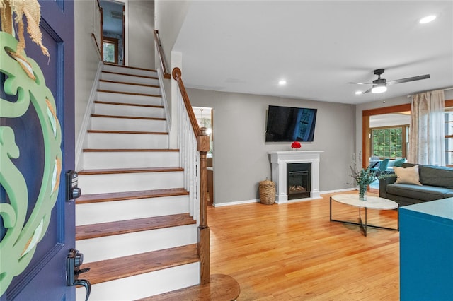 16 Lyncrest Rd, Cortlandt Manor, NY 10567 - living area featuring a ceiling fan, recessed lighting, stairs, light wood finished floors, and a fireplace with raised hearth