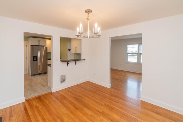 129 S St, Warwick, NY 10990 - spare room featuring a chandelier, light wood finished floors, and baseboards