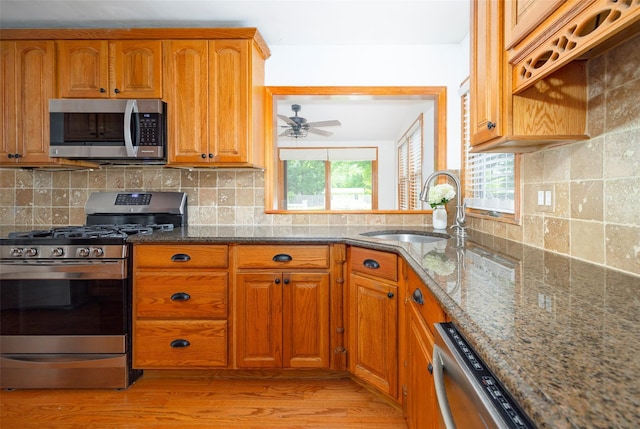 924 Violet Ave, Hyde Park, NY 12538 - kitchen featuring stainless steel appliances, a sink, light wood finished floors, stone counters, and tasteful backsplash