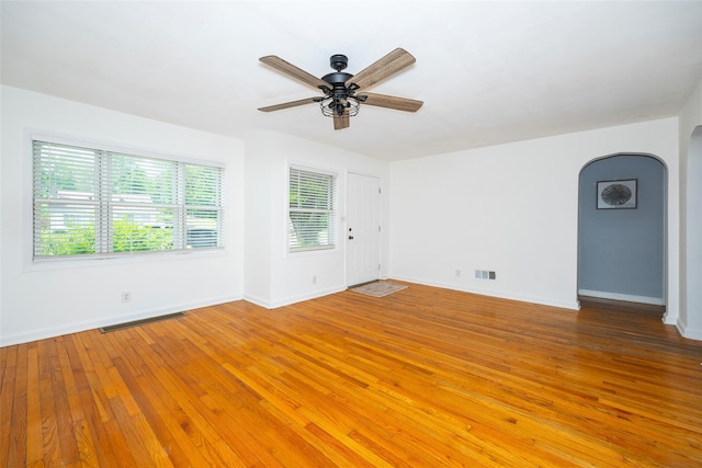 924 Violet Ave, Hyde Park, NY 12538 - empty room featuring arched walkways, light wood-style flooring, baseboards, and a ceiling fan