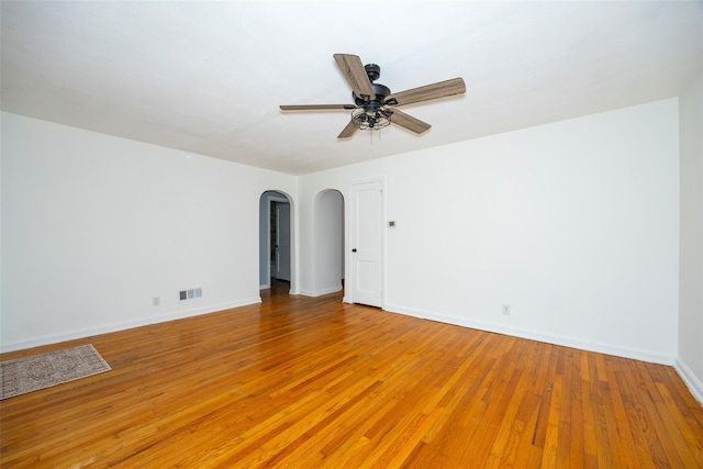 924 Violet Ave, Hyde Park, NY 12538 - unfurnished room with arched walkways, light wood finished floors, ceiling fan, and baseboards