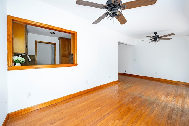 924 Violet Ave, Hyde Park, NY 12538 - spare room featuring a ceiling fan, light wood-style flooring, baseboards, and a sink