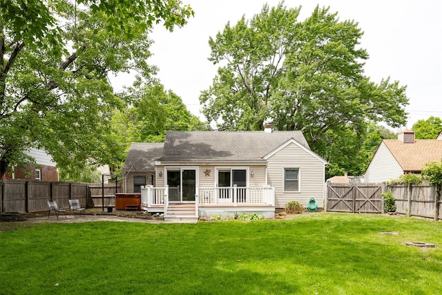 924 Violet Ave, Hyde Park, NY 12538 - rear view of property featuring a deck, roof with shingles, a patio area, a hot tub, and a chimney